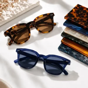 what is acetate eyewear — tortoiseshell and navy acetate sunglasses beside layered acetate sheet samples showing color depth