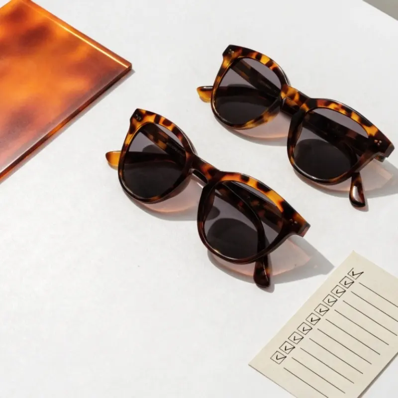 acetate eyewear quality control China factory — polished acetate frames with caliper measurement tool and QC checklist showing production standards
