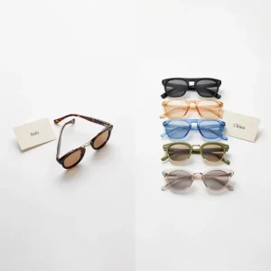 China vs Italy eyewear manufacturer comparison — handcrafted Italian acetate sunglasses beside varied Chinese production frames