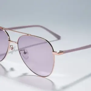 Rose gold metal aviator sunglasses with purple tinted lenses and double bridge construction, close-up detail view