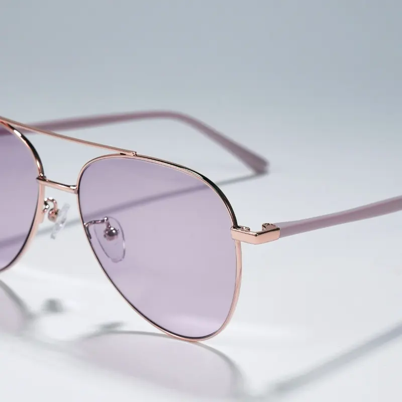 Rose gold metal aviator sunglasses with purple tinted lenses and double bridge construction, close-up detail view