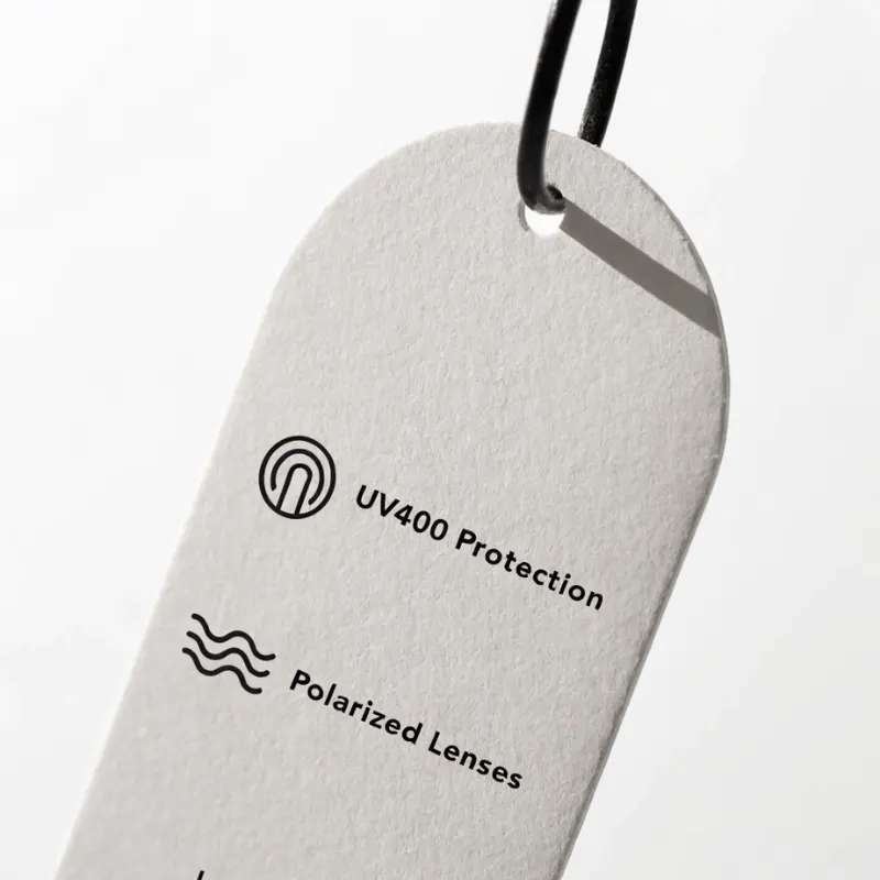 Sunglasses hang tag showing UV400 and polarized lens claims — correct labeling for eyewear brand packaging compliance