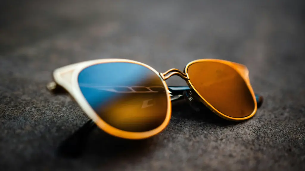 Titanium sunglasses temple with laser-engraved logo and anodized color sheen — customization options for eyewear brands