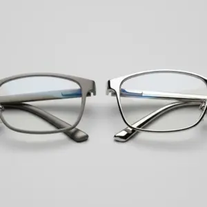 Titanium sunglasses frame beside stainless steel frame — material comparison for eyewear brands
