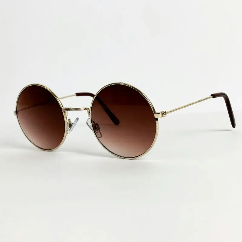 Gold round metal sunglasses with gradient brown lenses and brown temple tips on white background, classic vintage-style silhouette