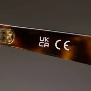 CE and UKCA marks printed on the inside temple arm of acetate sunglasses, showing correct conformity marking placement
