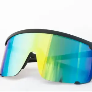 Close-up of a man wearing black shield-style sports sunglasses with a mirrored gold lens