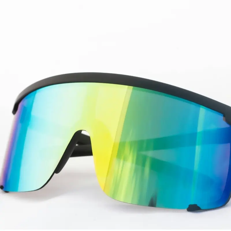 Close-up of a man wearing black shield-style sports sunglasses with a mirrored gold lens