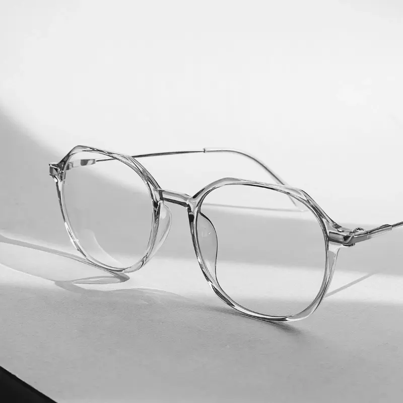 Close-up of a clear acetate optical frame showing the lens groove and rim where a prescription lens is glazed